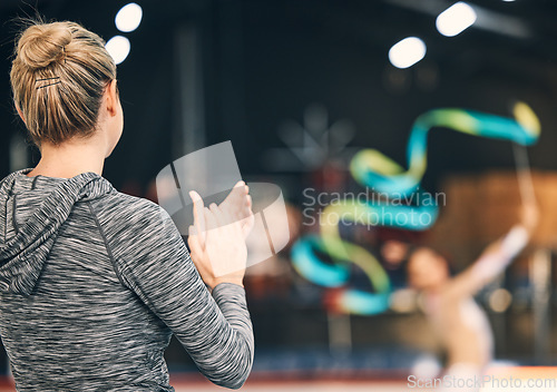 Image of Coaching, gymnastics and clapping with woman in stadium for training, fitness and teaching. Celebration, sports and workout practice with coach and acrobat for performance, flexibility and show