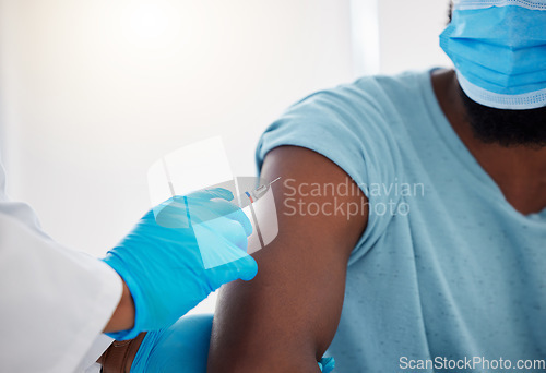 Image of Hand, arm and covid vaccine with doctor and patient in hospital, safety from virus with needle and healthcare. People in medical consultation, immunization and black man in face mask and injection