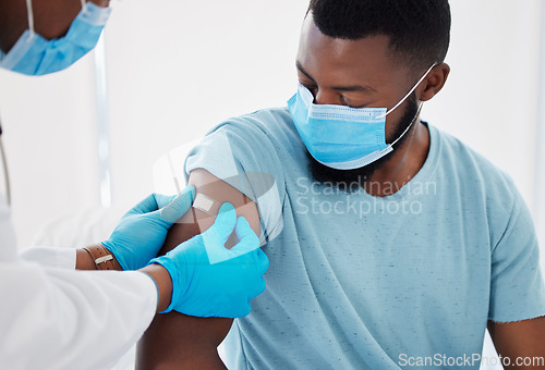 Image of Bandage, covid vaccine with doctor and patient in hospital, safety from virus with plaster and healthcare. People in medical consultation, immunization and black man in face mask and injection wound