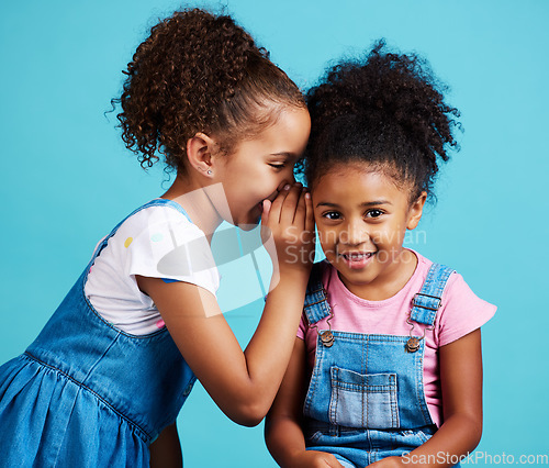 Image of Whisper, secret and friends with children in studio for gossip, rumor and good news. Communication, mystery and innocence with young girls on blue background for conversation, secrecy or cute mockup