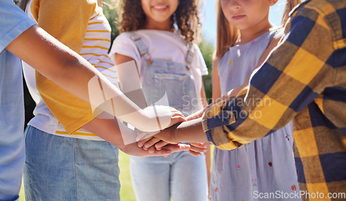 Image of Hands together, support and children outdoor, solidarity and trust with motivation, games or growth. Closeup, kids or youth group with gesture for teamwork, commitment or fun with development or goal