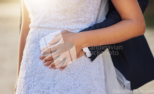 Image of Wedding, hug and hands of couple with ring for marriage ceremony, commitment and trust outdoors. Love, relationship and man and woman with diamond jewelry for partnership, embrace and celebration