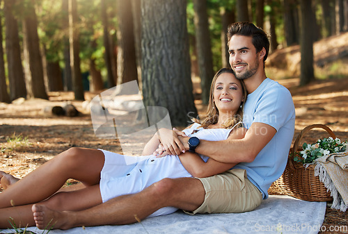Image of Couple in nature park, cuddle and happy relationship with love and trust, travel and adventure outdoor. Young people hug in forest, outside and happiness together with smile, commitment and care