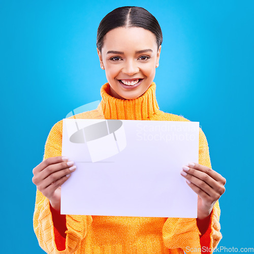 Image of Smile, mockup and poster with portrait of woman in studio for idea, branding and announcement. Promotion, space and paper with female and sign on blue background for news, logo and advertising