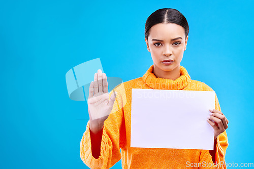 Image of Serious, stop and woman with a poster in a studio with mockup, copy space and blank space. Confidence, portrait and female model from Brazil with a paper and hand gesture isolated by blue background.