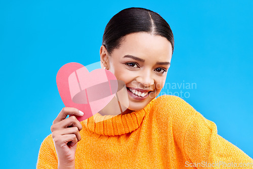 Image of Paper heart, happy woman and portrait on blue background, studio and backdrop. Female model, smile and shape of love, trust and support of peace, thank you and kindness on valentines day for romance