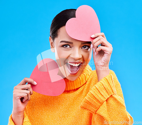 Image of Paper heart, excited woman and surprise on blue background, studio and emoji icon. Happy female model, love and shape of sign, wow and celebration of peace, thank you and kindness for valentines day