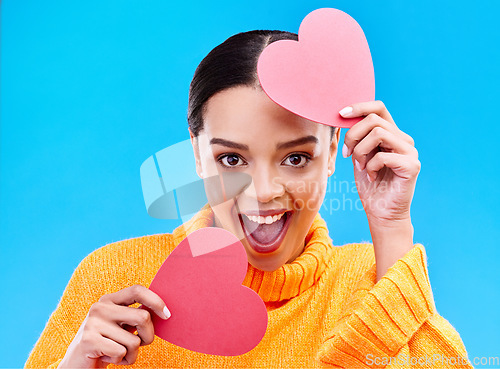 Image of Paper heart, excited woman and portrait on blue background, studio and emoji icon. Happy female model, love and shape of sign, surprise and celebration of peace, thank you and kindness for valentines