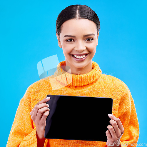 Image of Tablet, mockup and smile with portrait of woman in studio for website, technology and social media. Networking, internet and connection with female on blue background for app, announcement and search