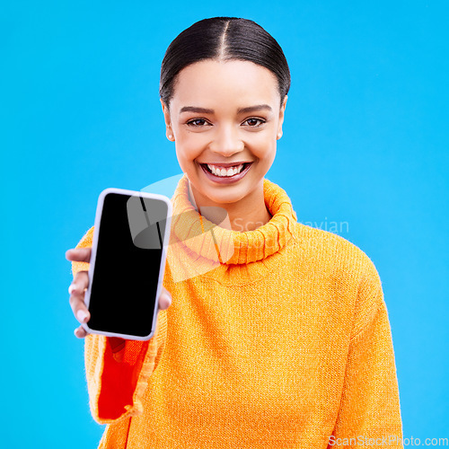 Image of Phone, mockup and portrait of woman in studio for website, technology and social media news. Networking, internet and connection with female on blue background for app, logo and search