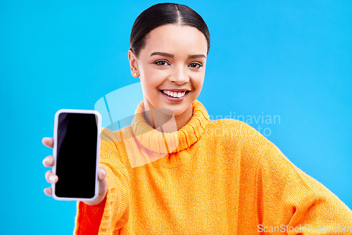 Image of Phone, mockup and smile with portrait of woman in studio for website, technology and social media. Networking, internet and connection with female on blue background for app, announcement and search