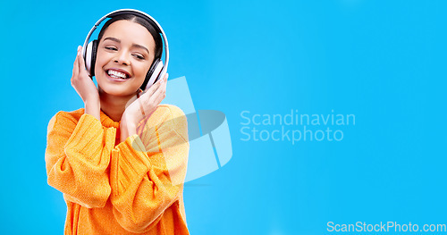 Image of Music headphones, woman and smile on blue background, mockup studio and backdrop. Happy female, gen z model and listening to sound, streaming album and audio connection on media, mock up and podcast