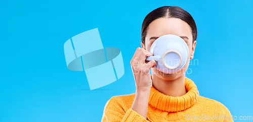 Image of Cup, woman and drinking coffee on blue background, relax and enjoying a warm beverage on against a blue background. Tea, mug and girl relaxing on break with drink, caffeine or espresso in studio