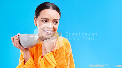 Image of Coffee, woman and smile in studio with mockup and happiness and mug. Isolated, blue background and happy female model and young person with casual winter fashion and joy from tea drink smiling
