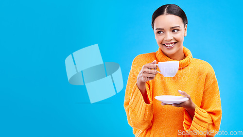 Image of Tea, woman and smile in studio with mockup and happiness with mug. Isolated, blue background and happy female model and young person relax with casual winter fashion and joy from hot drink smiling