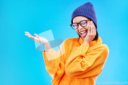 Image of Woman palm, happiness and portrait in a studio with promotion and announcement. Excited, isolated and blue background with mockup of a gen z girl and cool young female show marketing with smile