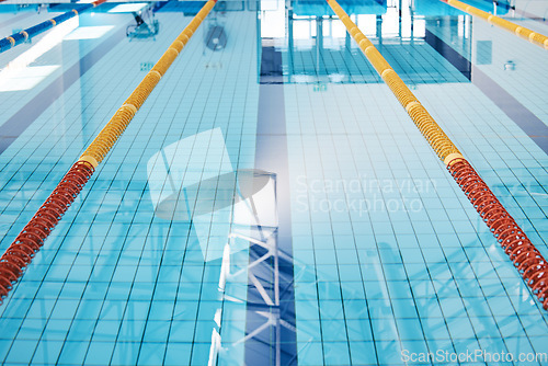 Image of Swimming, lane and water at an indoor pool for sports, recreation and weekend fun. Empty, training and a rows for competition, sport race or practice cardio for athletes or leisure activities