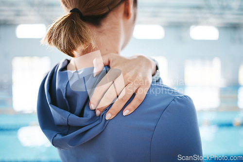 Image of Hands, back pain and injury at swimming pool after exercise, training or workout accident. Sports, swim athlete and woman with ache, fibromyalgia or injured shoulder after exercising or practice