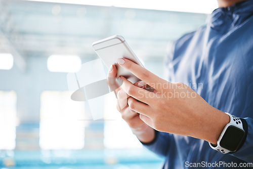 Image of Phone, hands and athlete texting at swimming pool for social media, web scrolling or online browsing after exercise. Swim sports, cellphone and woman typing on internet chat after workout or training