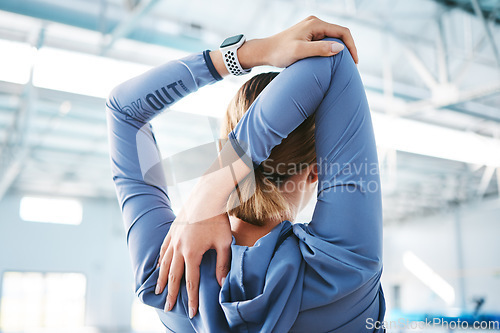 Image of Back, stretching arm and woman at gym for health, fitness and wellness. Sports, athlete and person warm up, stretch and getting ready for workout, training or exercise for flexibility or strength.