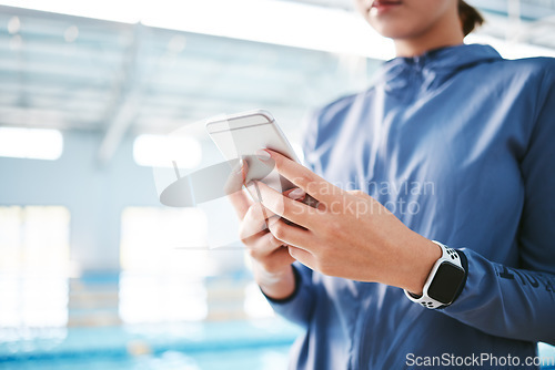 Image of Hands, phone and athlete texting at swimming pool for social media, web scrolling or online browsing after exercise. Swim sports, cellphone and woman typing on internet chat after workout or training