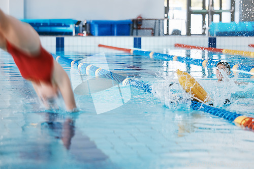 Image of Swimming pool, sports and woman diving in water for training, exercise and workout for competition. Fitness, swimmer and professional person dive, athlete in action and jump for health and wellness.