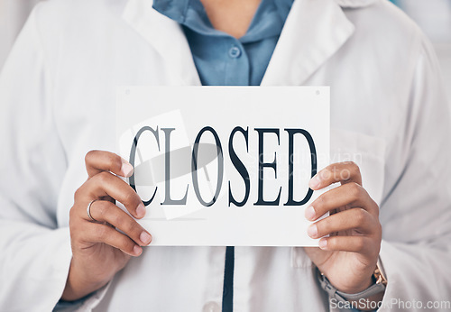 Image of Hands closeup, closed sign and small business for store, pharmacy or shop in recession, bankrupt and retail. Woman pharmacist, poster or board for announcement for medical shopping for healthcare