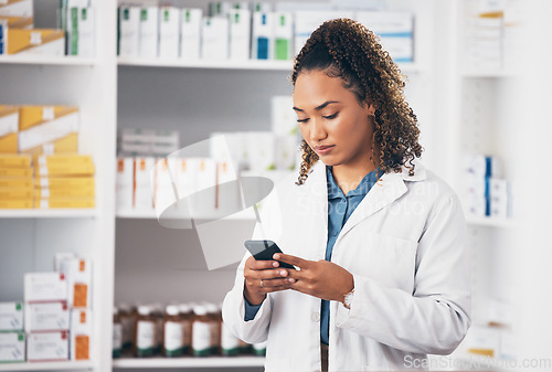 Image of Pharmacist woman, smartphone and texting in store for contact, email communication or reading chat. Pharmacy, female and phone for social media app, typing and medical news on internet in workplace