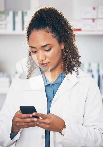 Image of Pharmacist woman, phone and texting in store for contact, email communication or reading chat. Pharmacy, female and smartphone for social media app, typing and medical news on internet in workplace