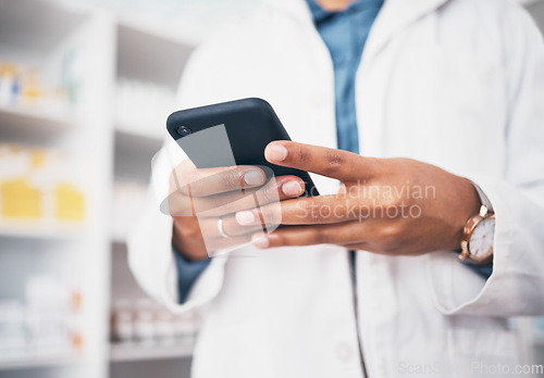 Image of Hands, phone and medicine with a pharmacist woman at work in a drugstore or dispensary for communication. Pharmacy, mobile or contact with a female professional in healthcare working at an apothecary