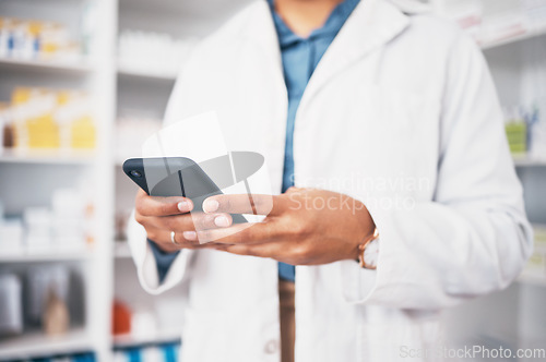 Image of Hands, phone and medical with a pharmacist woman at work in a drugstore for healthcare or communication. Pharmacy, mobile and contact with a female medicine professional working in a dispensary