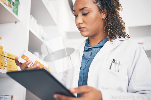 Image of Tablet, stock and healthcare with a pharmacist woman at work to fill an online order or prescription. Medical, product and insurance with a female working as a medicine professional in a pharmacy