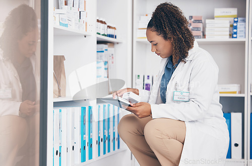 Image of Tablet, stock and product with a woman in a pharmacy to fill an online order of prescription treatment. Medical, healthcare and insurance with a female pharmacist working as a medicine professional