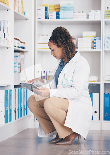 Image of Tablet, stock and health with a pharmacist woman at work to fill an online order or prescription. Healthcare, product and insurance with a female working as a medicine professional in a pharmacy