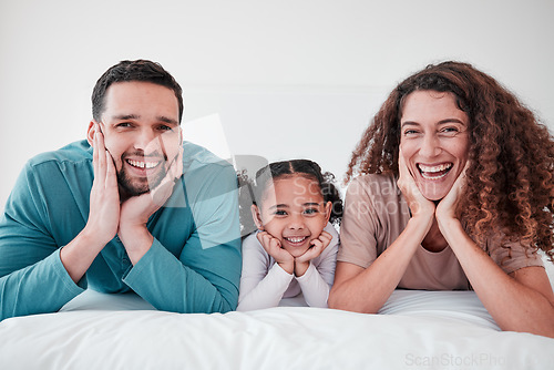 Image of Family, portrait and parents with child, smile and relax with happiness, love and care in bedroom. Spending quality time together, bonding and relationship, man and woman with young girl at home