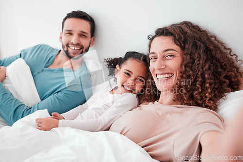 Image of Selfie, bedroom and portrait of parents with girl in bed relax for quality time, bonding and love in morning. Family home, face and happy mother, father and child smile for picture, post and memory