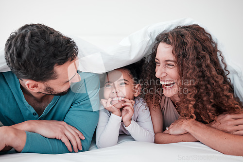 Image of Family in bed, parents laughing with child and relax with smile under blanket in bedroom with love and care. Spending time together, bonding and relationship, man and woman with young girl at home