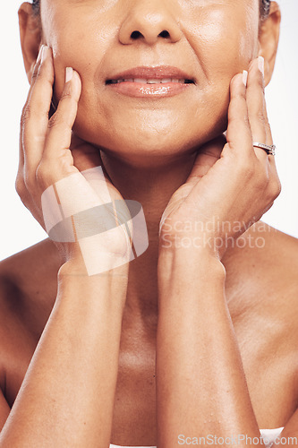 Image of Hands, mouth and skincare with a mature woman in studio for beauty, anti aging treatment or cosmetics. Skin, facial and wellness with a senior female touching her smooth face for hydration closeup