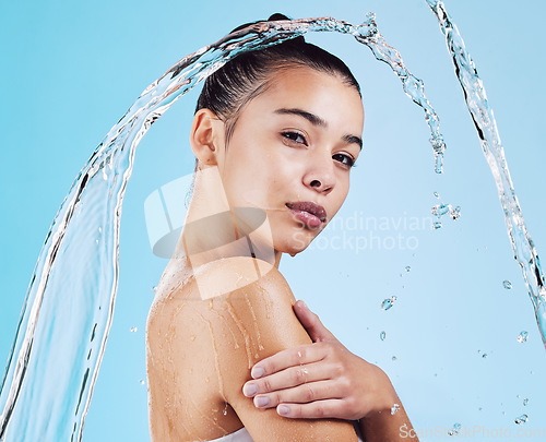 Image of Water drops, skincare and portrait of woman with health, wellness and hygiene isolated on blue studio background. Shower, dermatology and cosmetic beauty glow, model in skin care treatment or routine