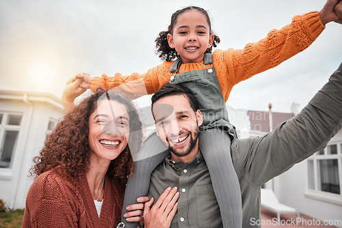 Image of Family portrait, piggy back and happy man, woman and child in yard of new house, happiness and security at home. Interracial mother, father and girl bonding in backyard together with love and smile.