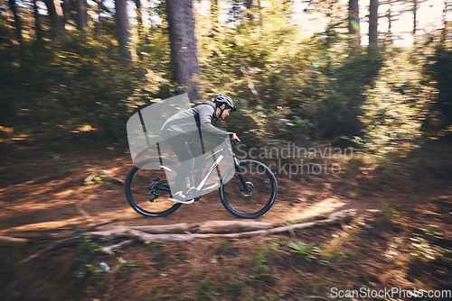 Image of Man, outdoor and cycling in nature for sports, exercise or training on a mountain bike with speed. Athlete male person on a bicycle for a fitness workout for energy in a forest with green trees