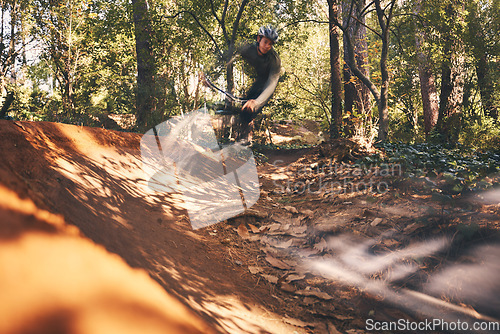 Image of Bike, fitness and motion blur with a man in the forest for cycling, adventure or freedom in nature. Bicycle, exercise and a male athlete cyclist outdoor in the woods for cardio or endurance training