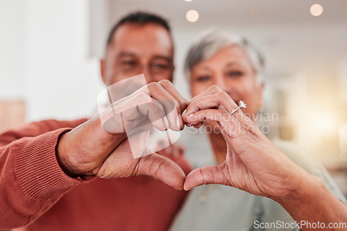 Image of Couple, senior and heart hands in home, love and bonding in retirement together. Romance, hand gesture and elderly man and woman with emoji for care, affection and empathy, commitment and trust.