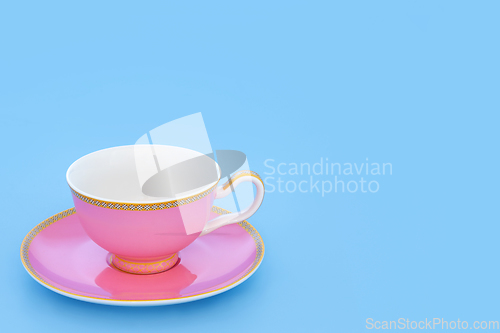 Image of Pink and Gold Porcelain Tea Cup on Blue Background