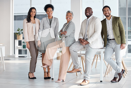 Image of Team, diversity and portrait of business people in the office posing together after a meeting. Collaboration, staff and multiracial group of colleagues or friends standing in the modern workplace.