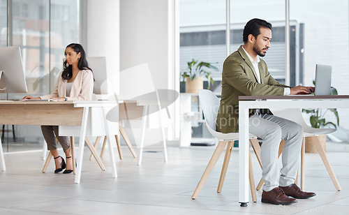 Image of Office, workspace and business people in startup typing on computer, digital marketing or coworking in building. Professional employees or man and woman working on laptop and desktop for productivity