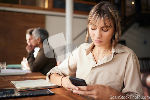 Image of Business, employee and woman with smartphone, serious and connection for social media, texting and sms. Female, entrepreneur and consultant with cellphone, communication and mobile app in workplace