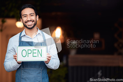 Image of Happy asian man, small business and open sign for service in coffee shop or restaurant. Portrait of male entrepreneur, manager or waiter holding billboard or poster for opening retail store or cafe