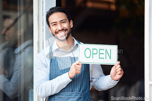 Image of Happy asian man, small business and portrait with open sign for service in coffee shop or restaurant. Male entrepreneur, manager or waiter holding billboard or poster for opening retail store or cafe