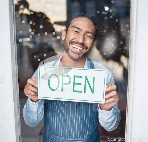 Image of Asian man, small business and face with open sign on window for service in coffee shop or restaurant. Portrait of happy male entrepreneur holding billboard or poster for opening, retail store or cafe